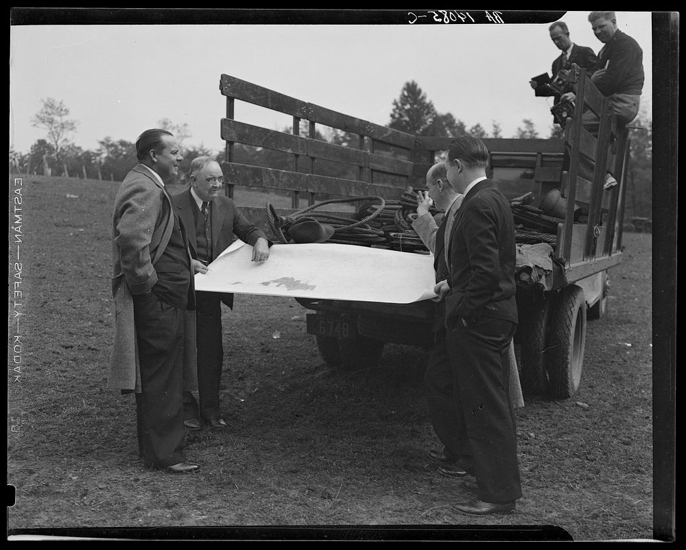 [Untitled photo, possibly related to: Officials examining plan of Greenbelt, Maryland]. Sourced from the Library of Congress.