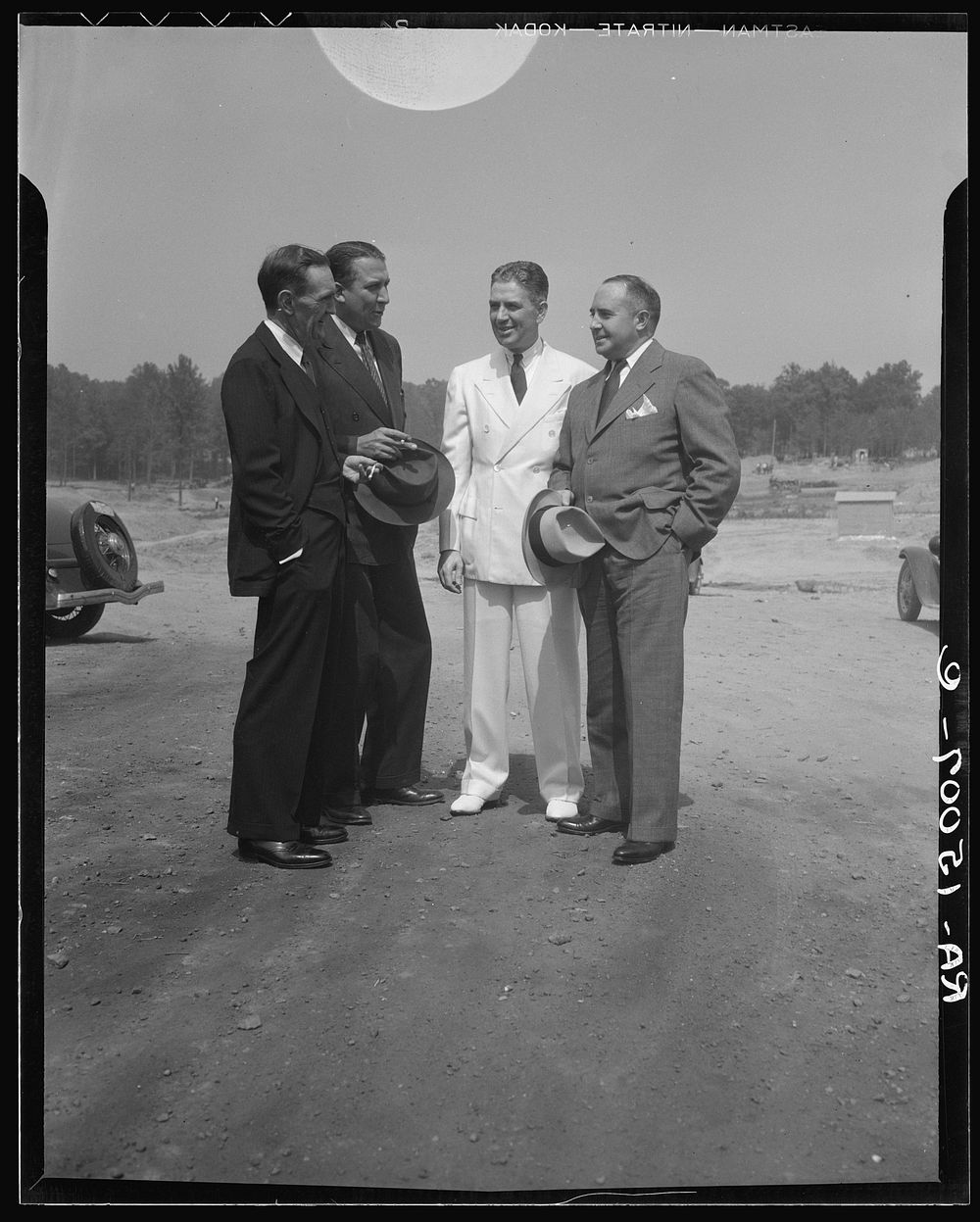 Resettlement Administrator R.G. Tugwell (in white), with his aides John O. Walker, John L. Lansill, and Frank Schmidt…