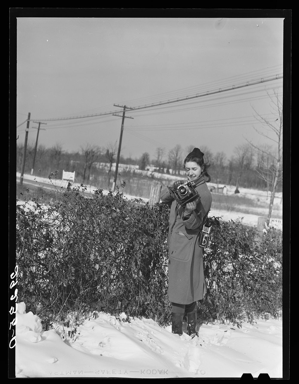[Untitled photo, possibly related to: Untitled negative showing Marion Post Wolcott standing in snow with cameras]. Sourced…