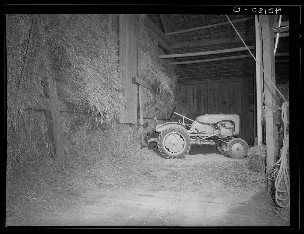 Maytown (vicinity), Lancaster County, Pennsylvania. Tractor in the barn on the farm of FSA (Farm Security Administration)…