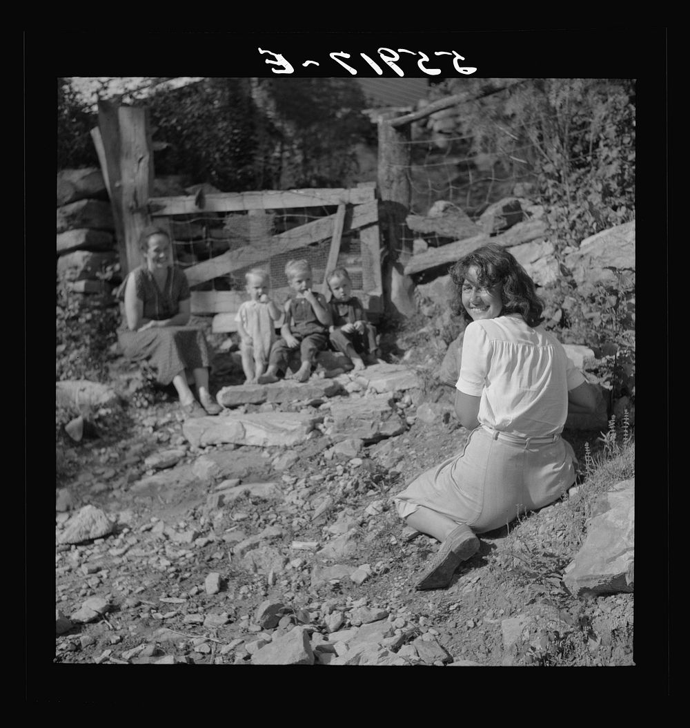 [Marion Post photographing mountain children on stone steps of their home. Up Stinking Creek, Pine Mountain, Kentucky].…