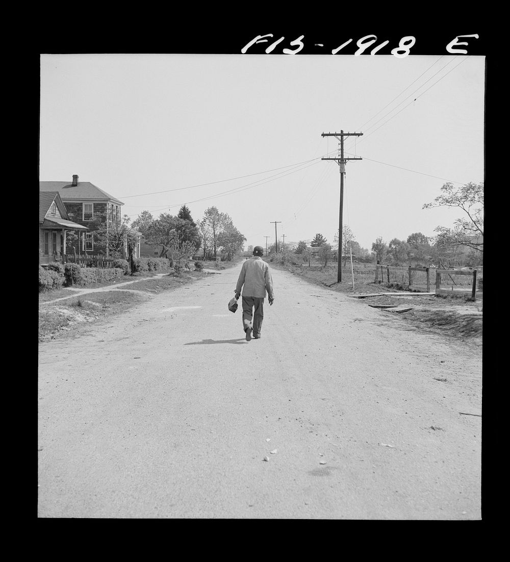 Newport News, Virginia.  shipyard worker leaving his rural home for the shipyards with his lunch box. Sourced from the…
