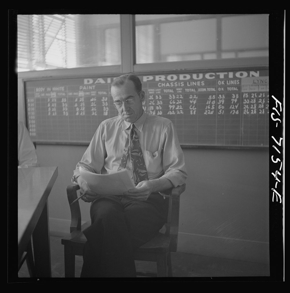 Detroit, Michigan (vicinity). Chrysler Corporation Dodge truck plant. Production supervisor discussing daily production at…