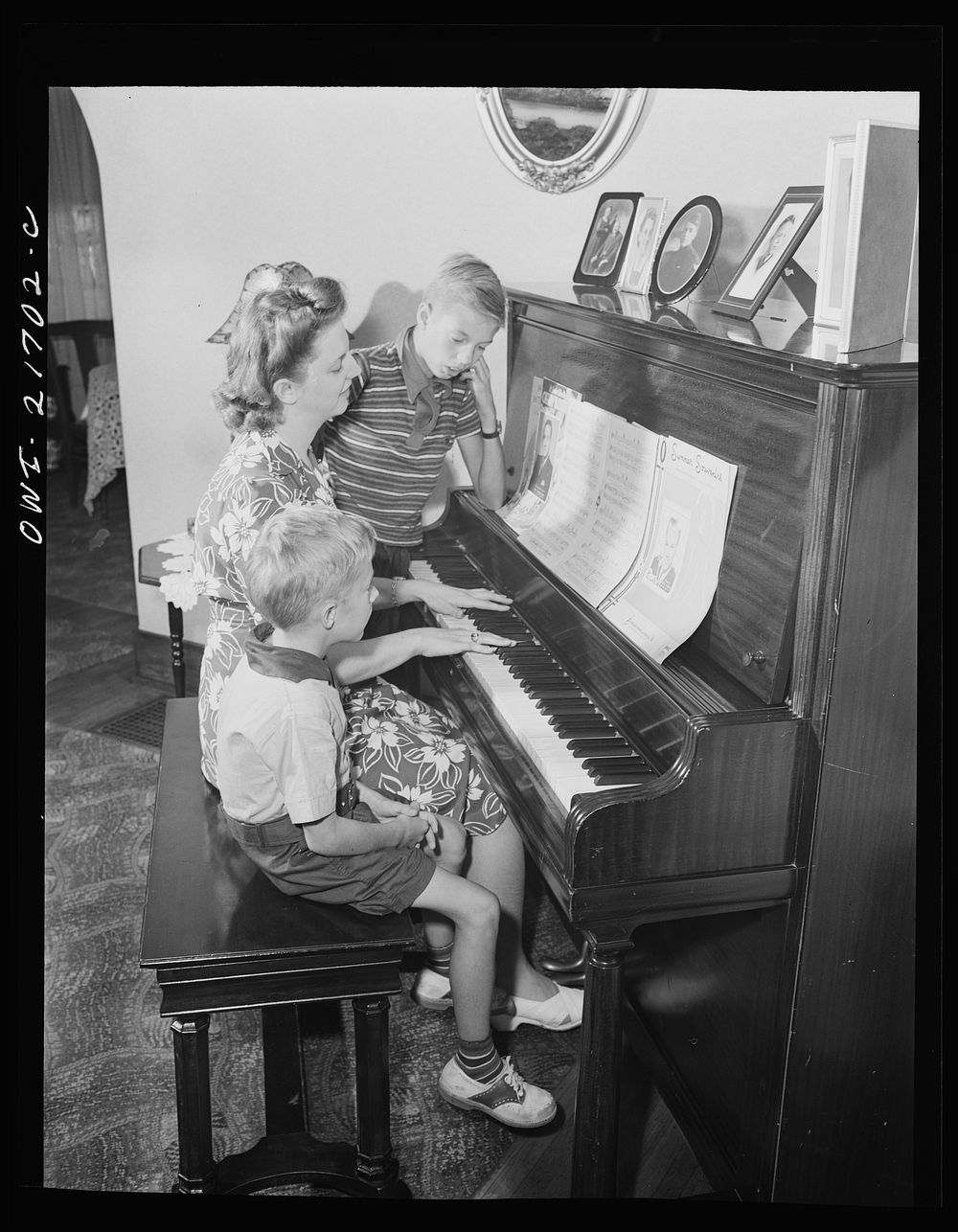 Rochester, New York. Howard and Earl Babcock enjoy singing to their mother's piano accompaniment. Sourced from the Library…