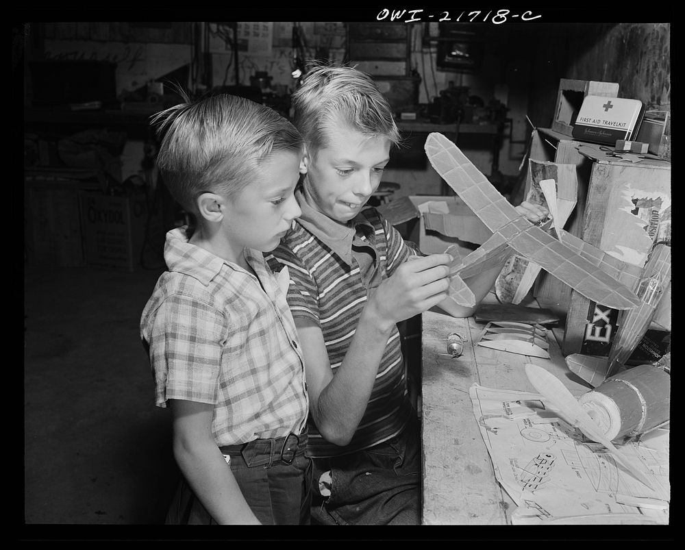Rochester, New York. Earl and Howard Babcock looking over one of the model airplanes which Howard built. Sourced from the…