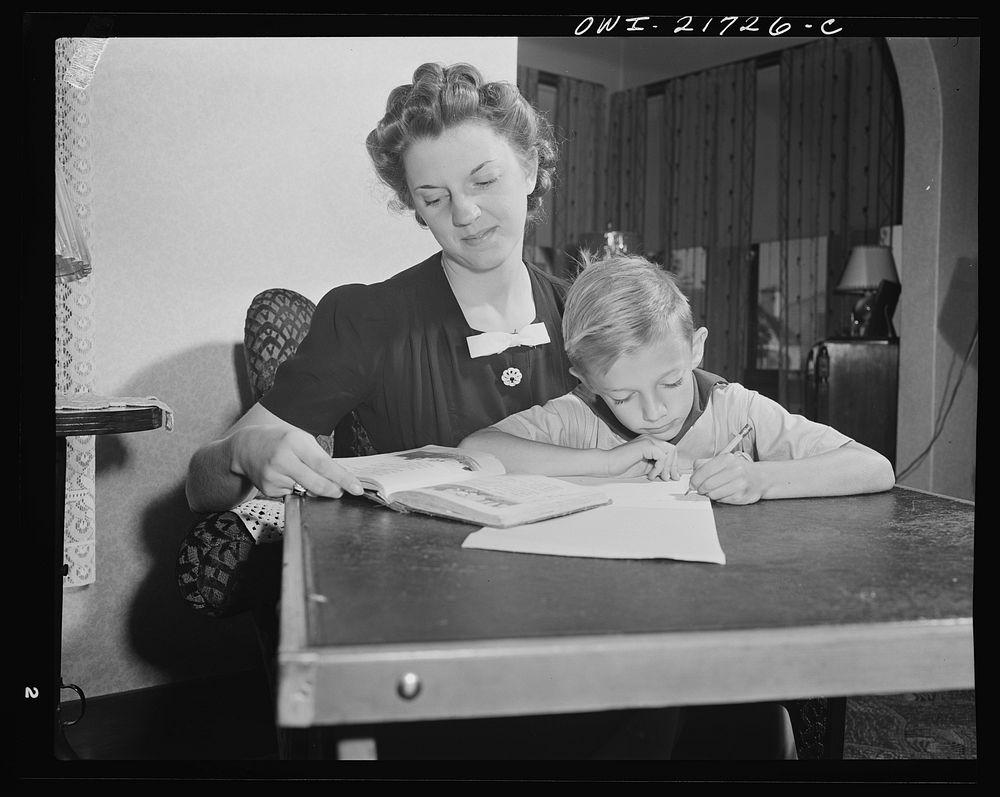 Rochester, New York. Shirley Babcock helping her brother Earl with his lessons. Sourced from the Library of Congress.