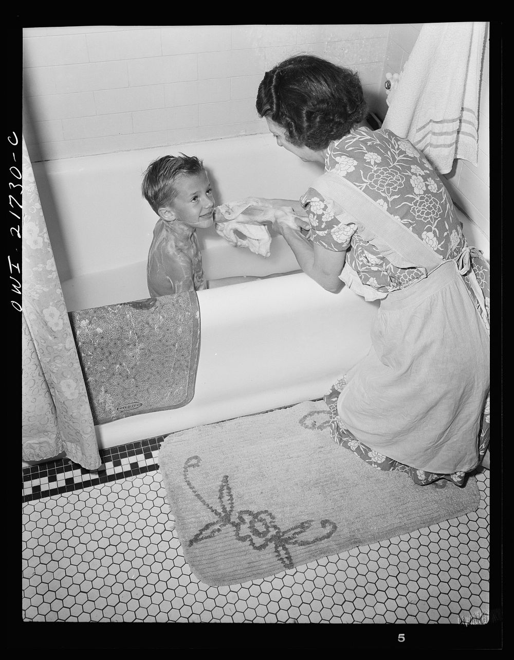 Rochester, New York. Earl Babcock's mother helping with his bath. Sourced from the Library of Congress.