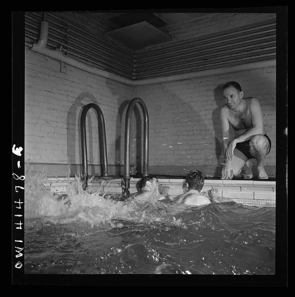 New York, New York. Irving Haeinowits, swimming instructor, giving instructions to two men in the pool at the Lighthouse, an…