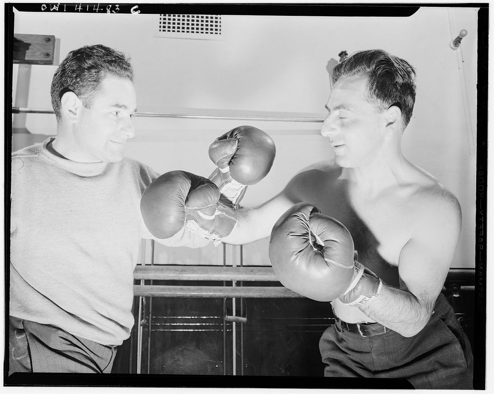 New York, New York. Maurice Case, boxing instructor, giving instructions to Joe Bruno (blind) at the Lighthouse, an…