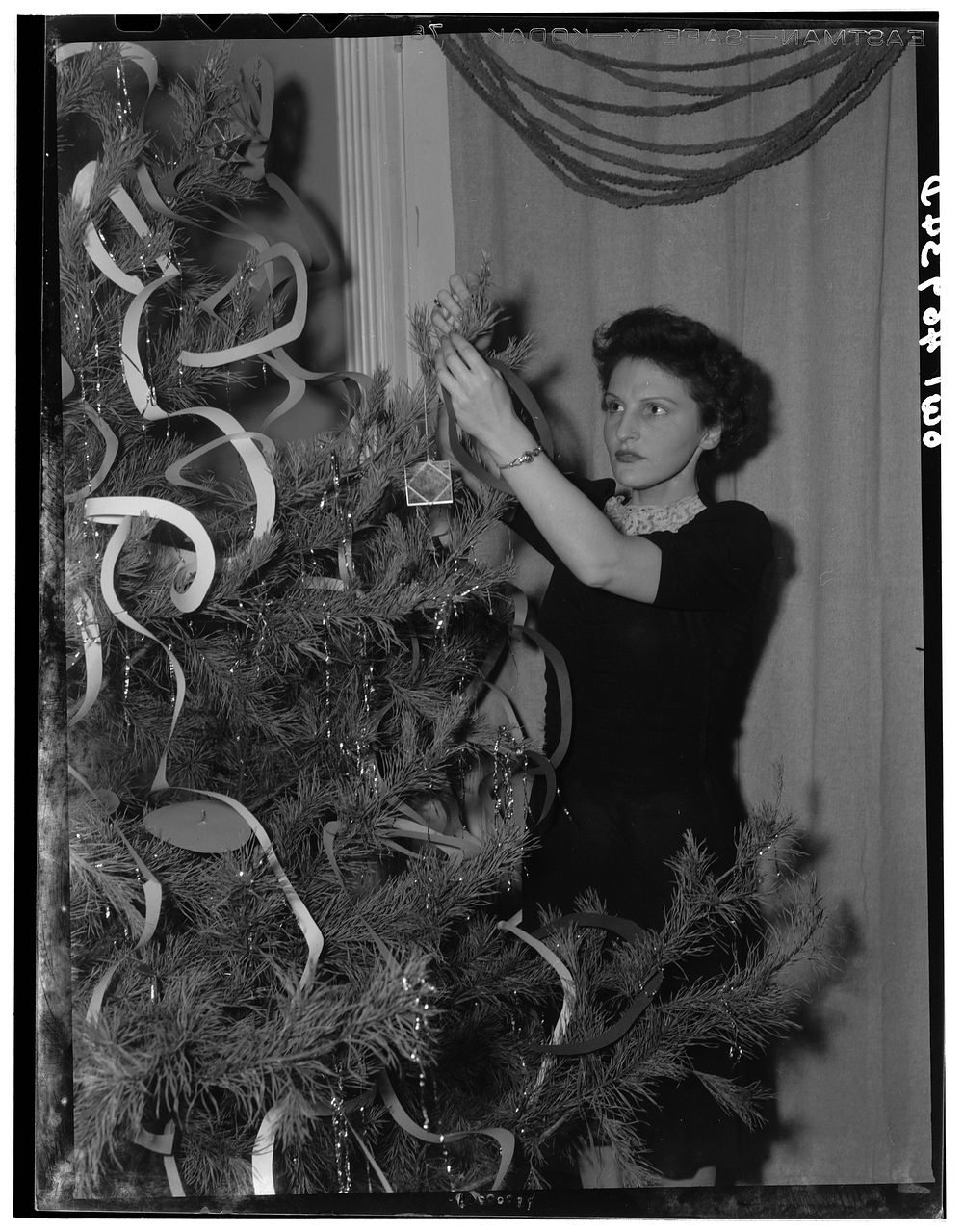 Washington, D.C. Decorating the tree at a Christmas Eve party given by Local 203 of the United Federal Workers of America…