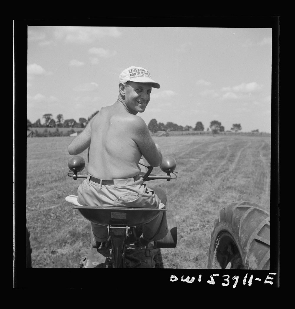 Dresher, Pennsylvania. The owner of the Spring Run Farm driving a tractor. Sourced from the Library of Congress.