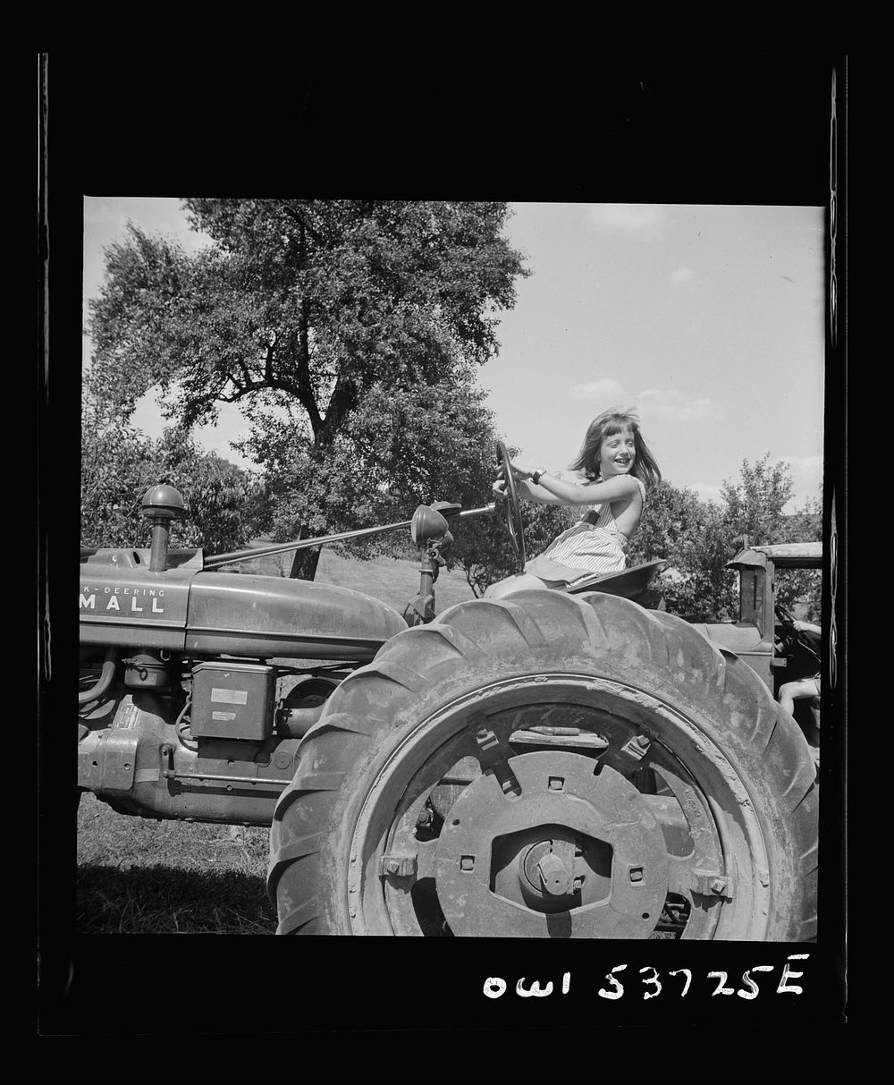 Dresher, Pennsylvania. The daughter of the owner of the Spring Run Farm on a tractor. Sourced from the Library of Congress.