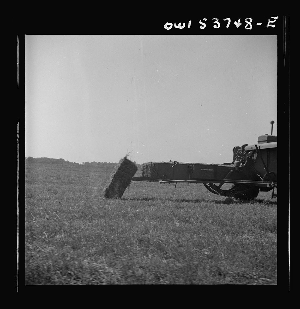 Dresher, Pennsylvania. A bale of hay being dropped off the hay baling machine. Sourced from the Library of Congress.