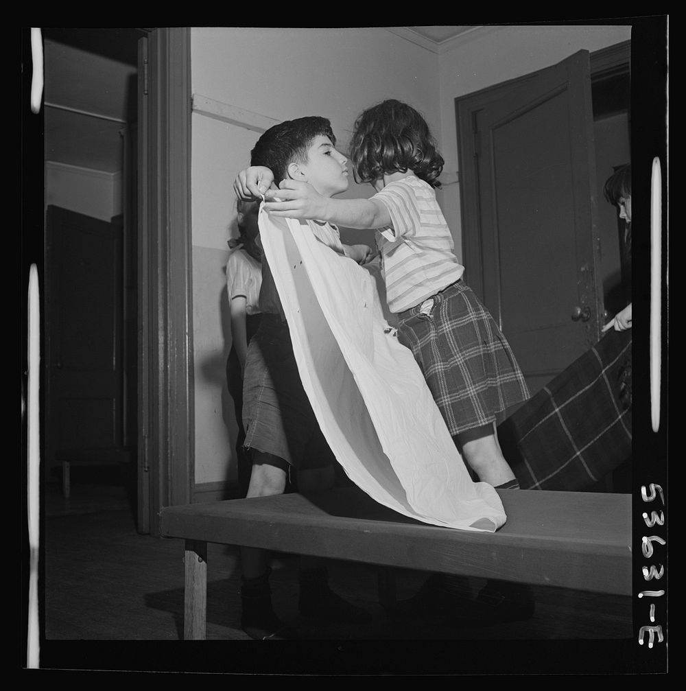 New York, New York. Children of working mothers, enrolled in a day care program at Greenwich House, tidying up after a rest…