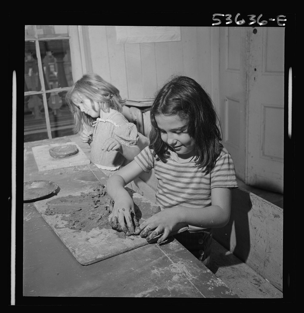 New York, New York. Two children of working mothers who receive day care at Greenwich House enjoying their work in clay.…