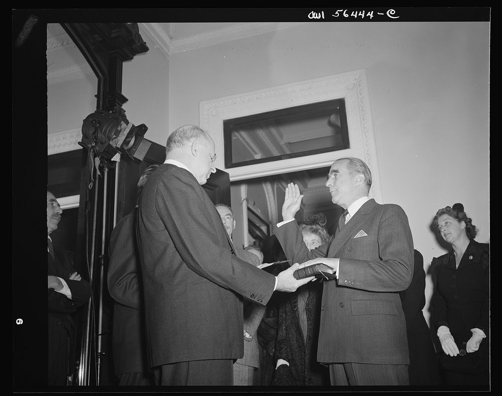 Justice Reed administering oath of office to James C. Dunn, Assistant Secretary in charge of European, Near Eastern, African…