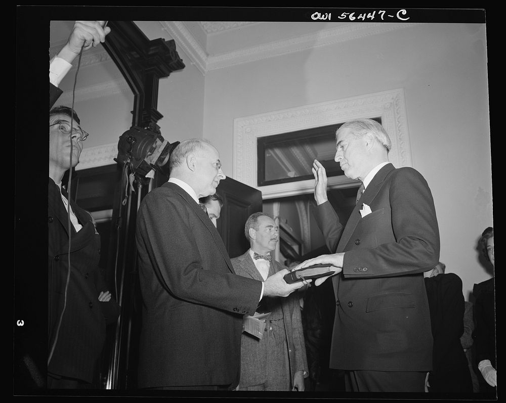 Justice Reed administering oath of office to William L. Clayton, Assistant Secretary in charge of Economic Affairs, U.S.…