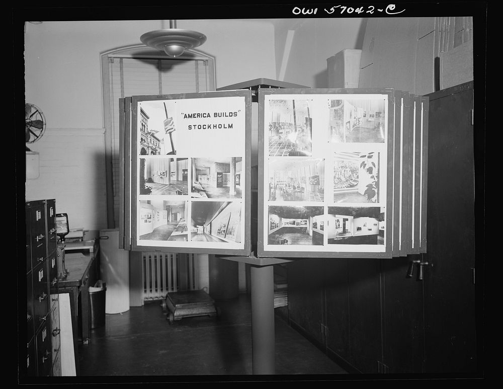 Installation of the United States Office of War Information (OWI) exhibit of original drawings and paintings by artists now…