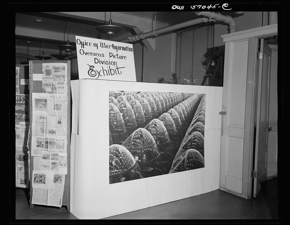 Installation of the United States Office of War Information (OWI) exhibit of original drawings and paintings by artists now…