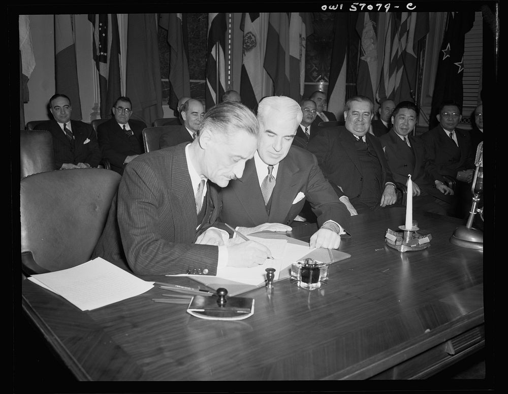 Washington, D.C. Henri Bonnet, French Ambassador, signing the United Nations declaration for France at the State Department.…
