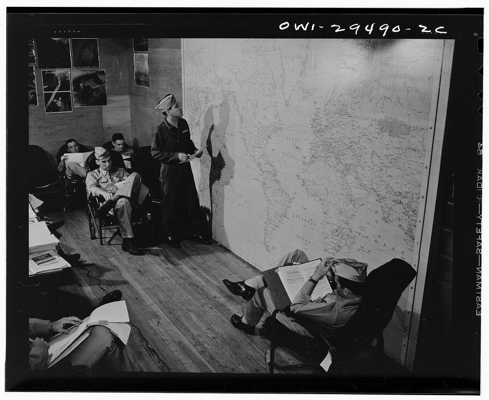 Pilots of the United States Army air transport command studying a map. Sourced from the Library of Congress.