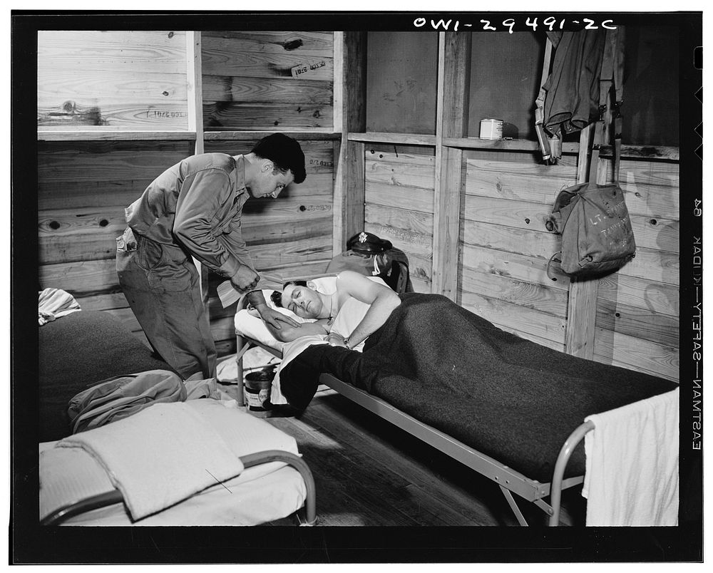 A pilot of the United States Army air transport command being awakened to receive orders. Sourced from the Library of…