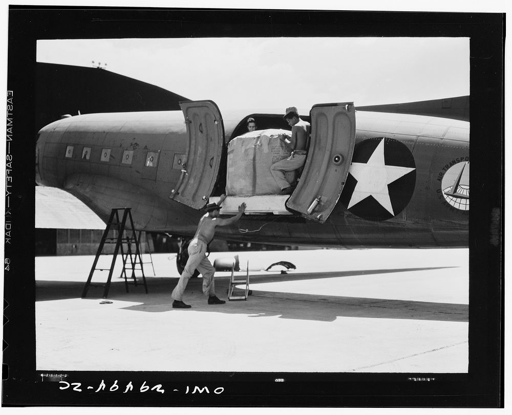 A plane of the United States Army air transport command being loaded. Sourced from the Library of Congress.