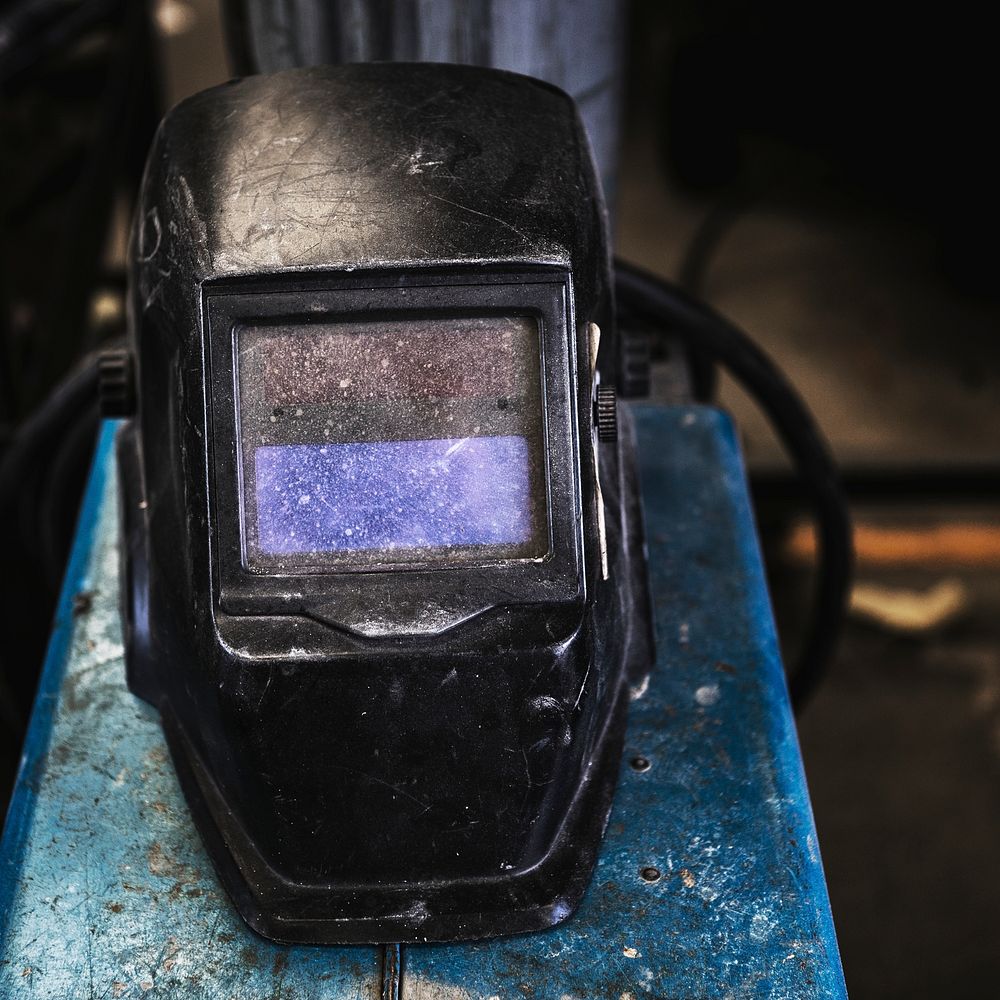 Black welding mask in a garage
