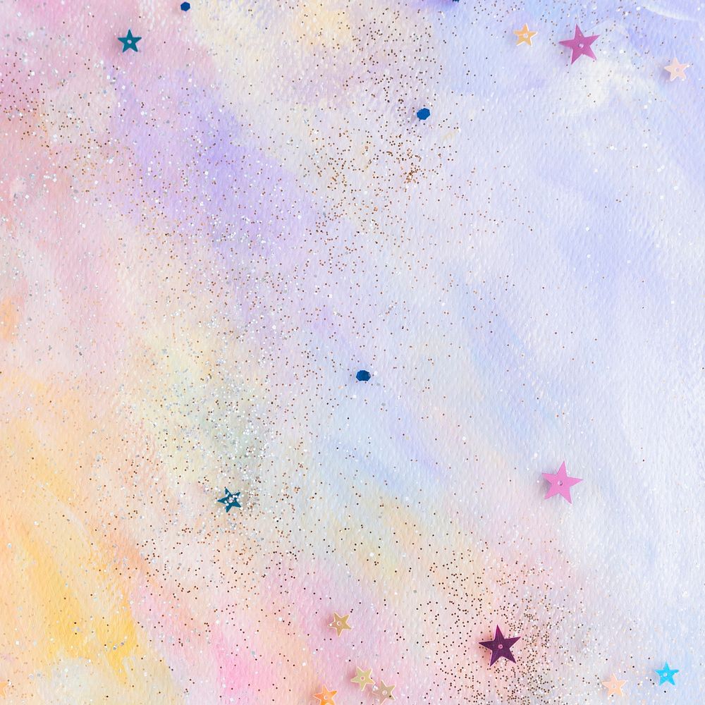 Glittery star confetti on colorful abstract pastel watercolor background