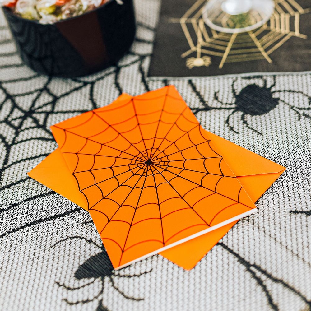 Orange Halloween spider web card on a spider lace tablecloth 