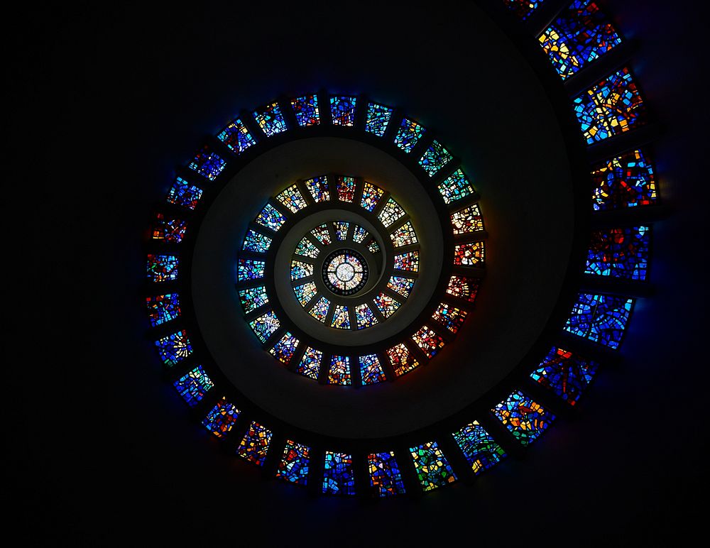 Architect Philip Johnson&rsquo;s stained-glass "Glory Window" unfolds in the spiraling 1976 Chapel of Thanksgiving, part of…