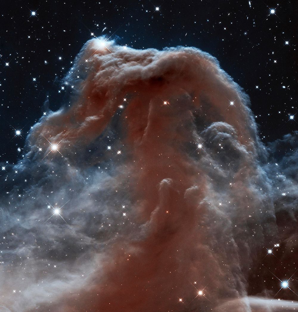 Backlit wisps along the Horsehead Nebula's upper ridge are being illuminated by Sigma Orionis. Original from NASA. Digitally…