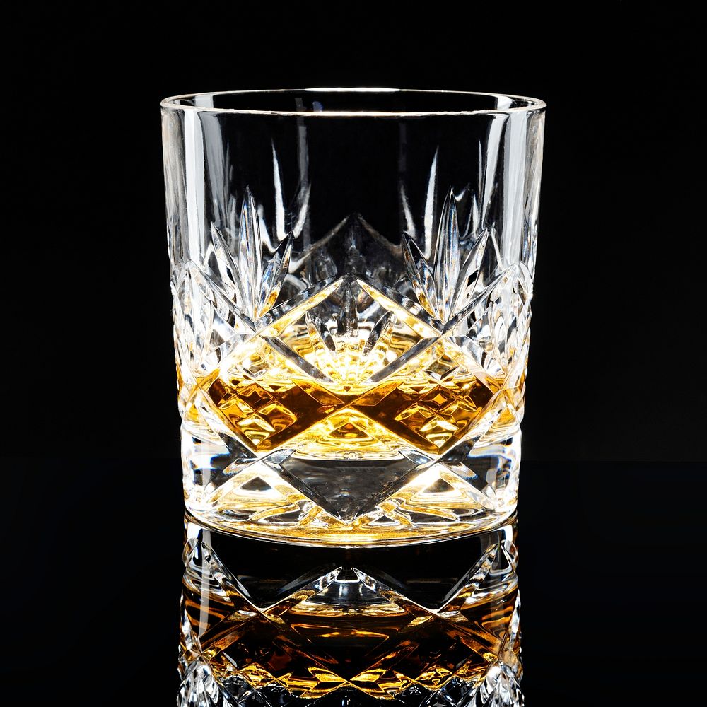 Golden scotch whisky on a black background