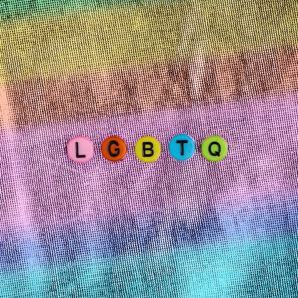 LGBTQ word beads lettering colorful background 