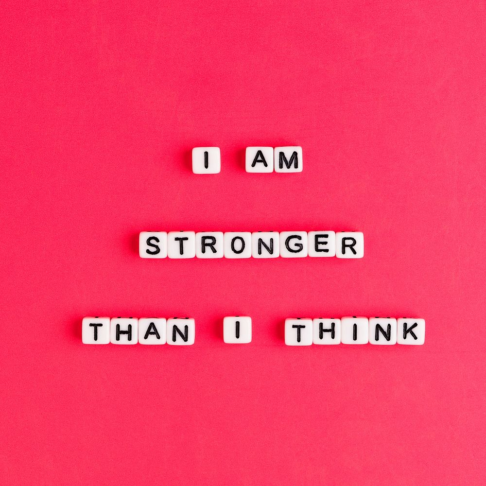White I AM STRONGER THAN I THINK beads word typography on red