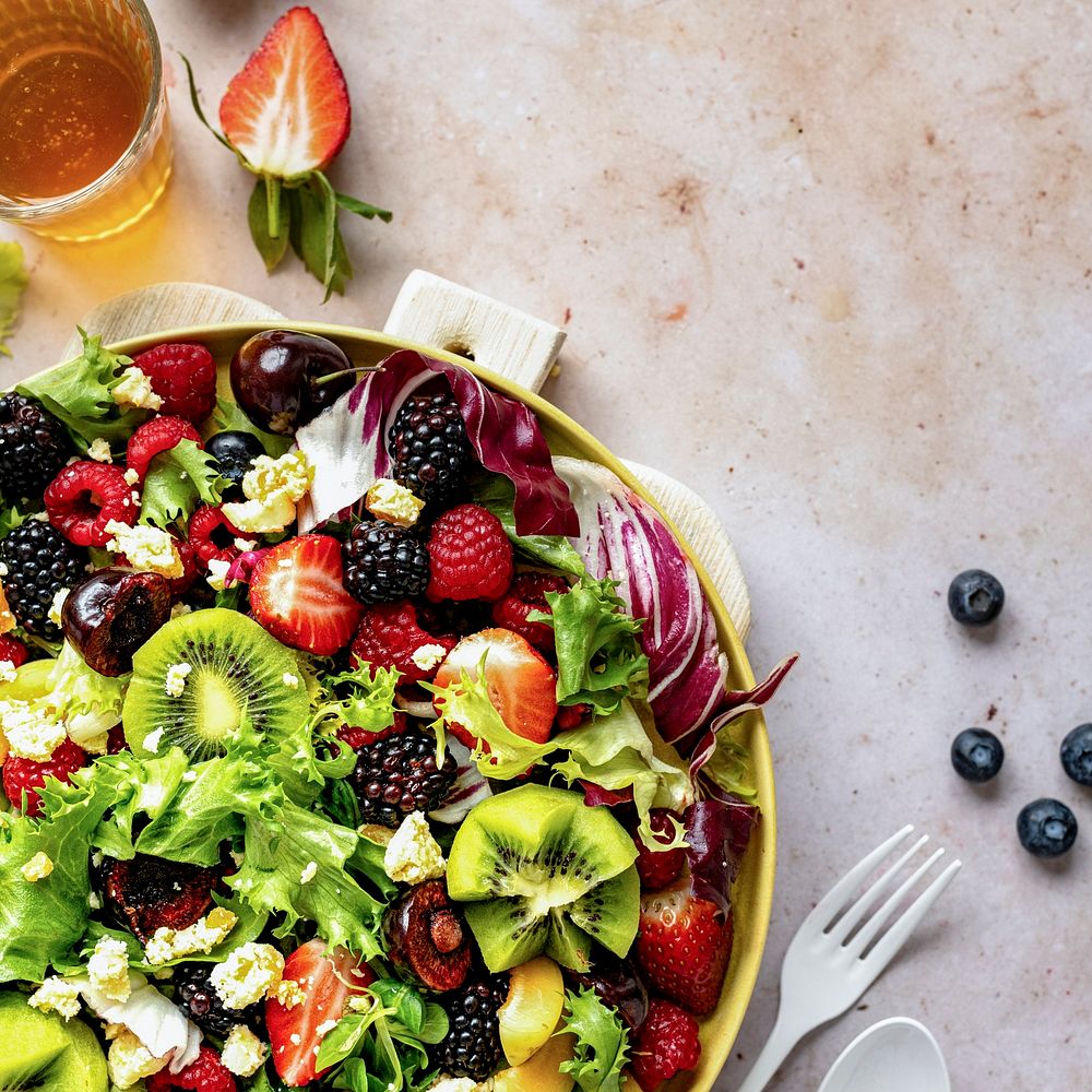 Healthy salad bowl with veggies and berries