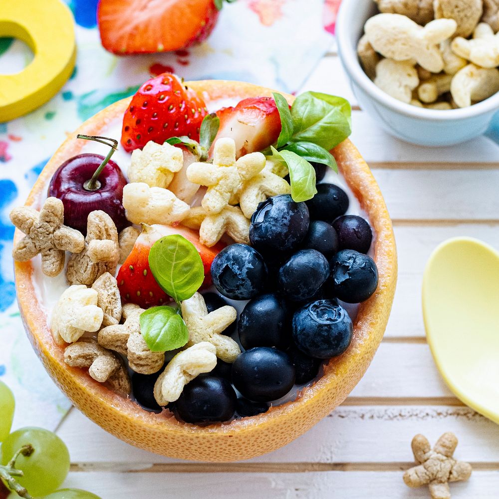 Kids cereal bowl treat with berries and yogurt