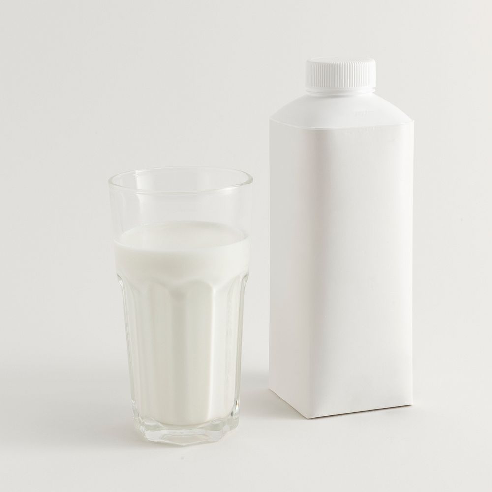 Fresh milk in a glass with a bottle