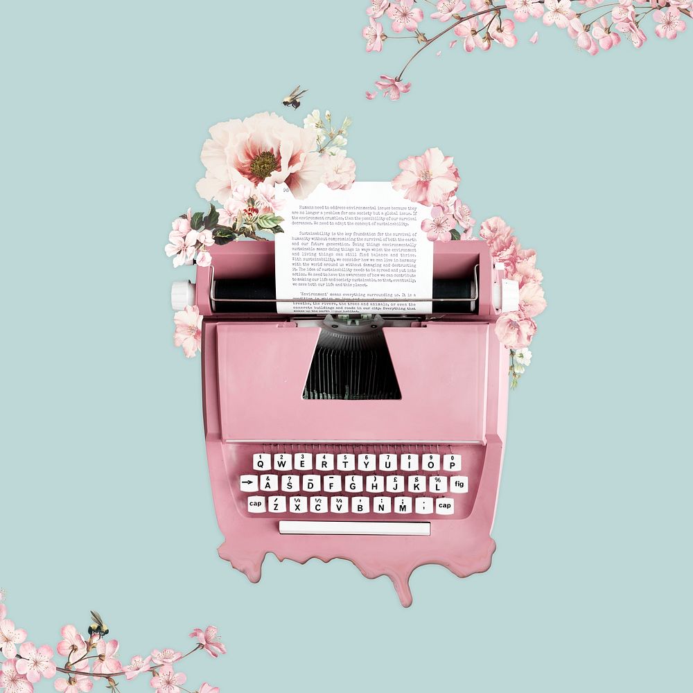 Pink typewriter decorated with flowers on a green background 