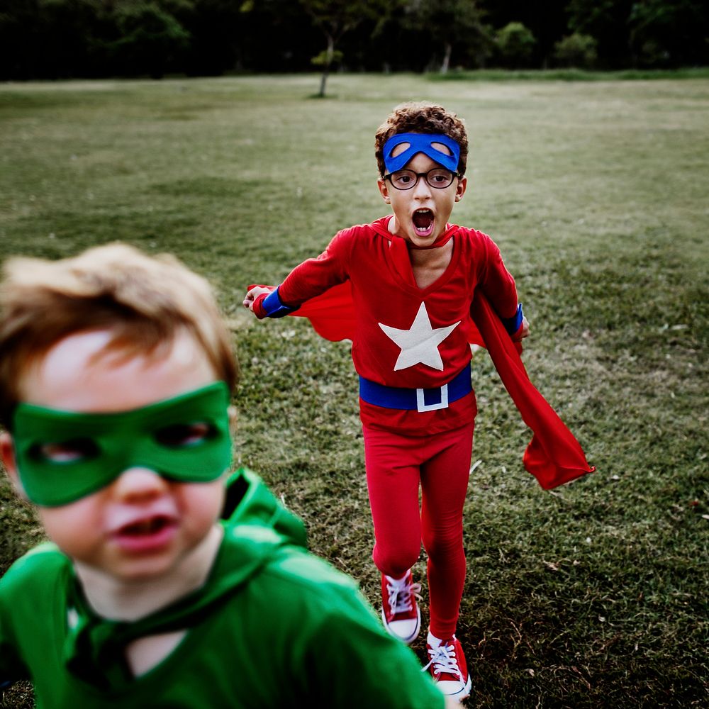 Superhero kids playing at the park