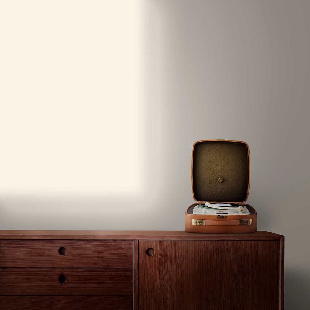 Vintage vinyl record player on wooden sideboard