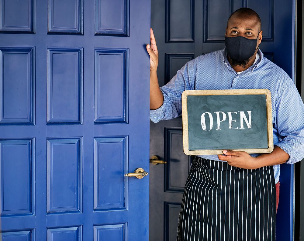 Black business owner in mask during new normal post pandemic