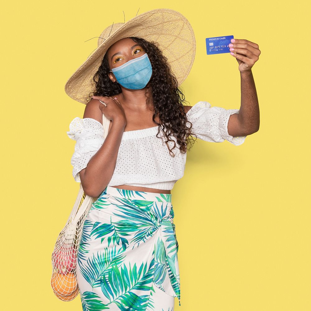 Covid 19, woman in medical mask holding a credit card