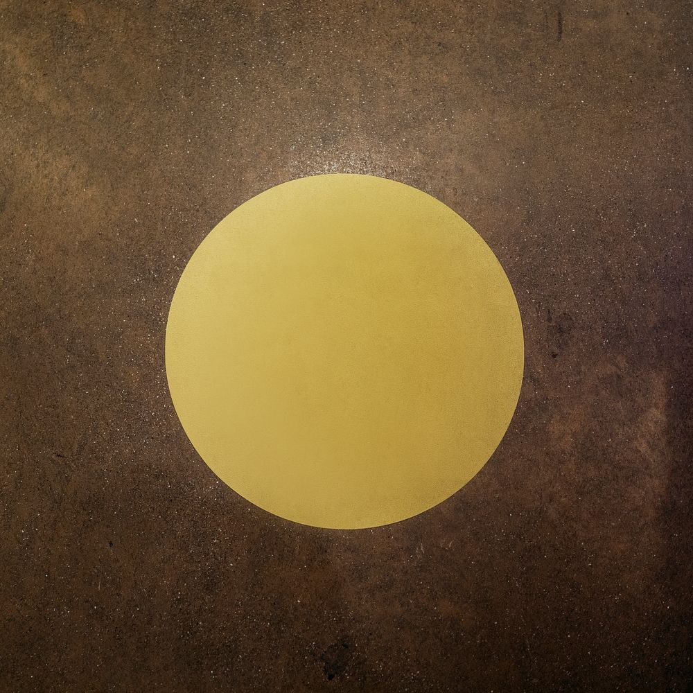 Round yellow sign on a brown background
