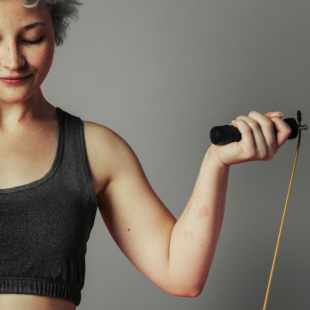 Sporty woman with jump rope at the gym 