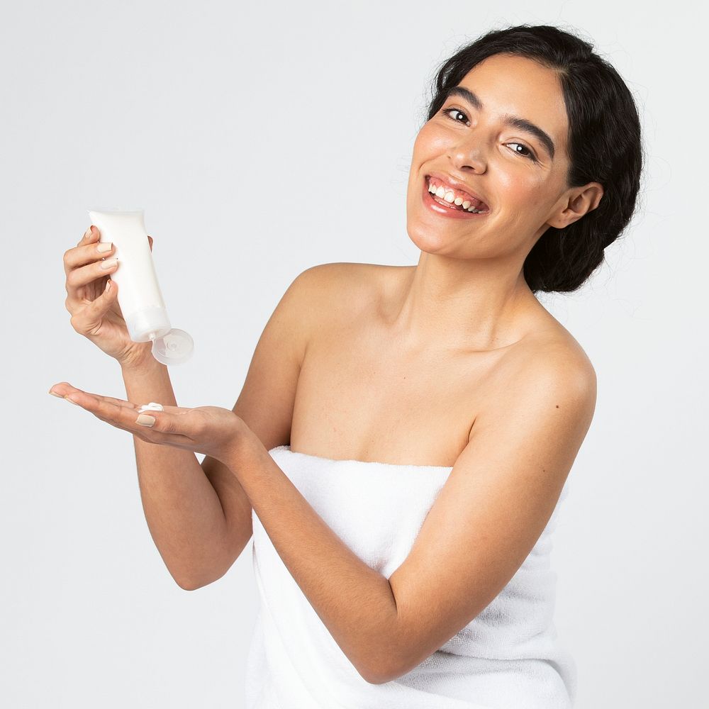 Beautiful woman holding a skin care product