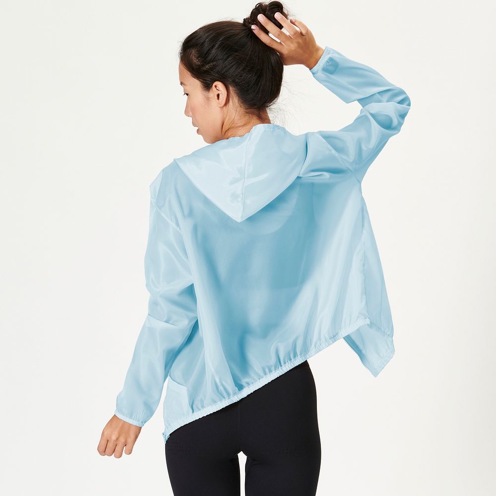 Rear view of a woman in a baby blue sports jacket