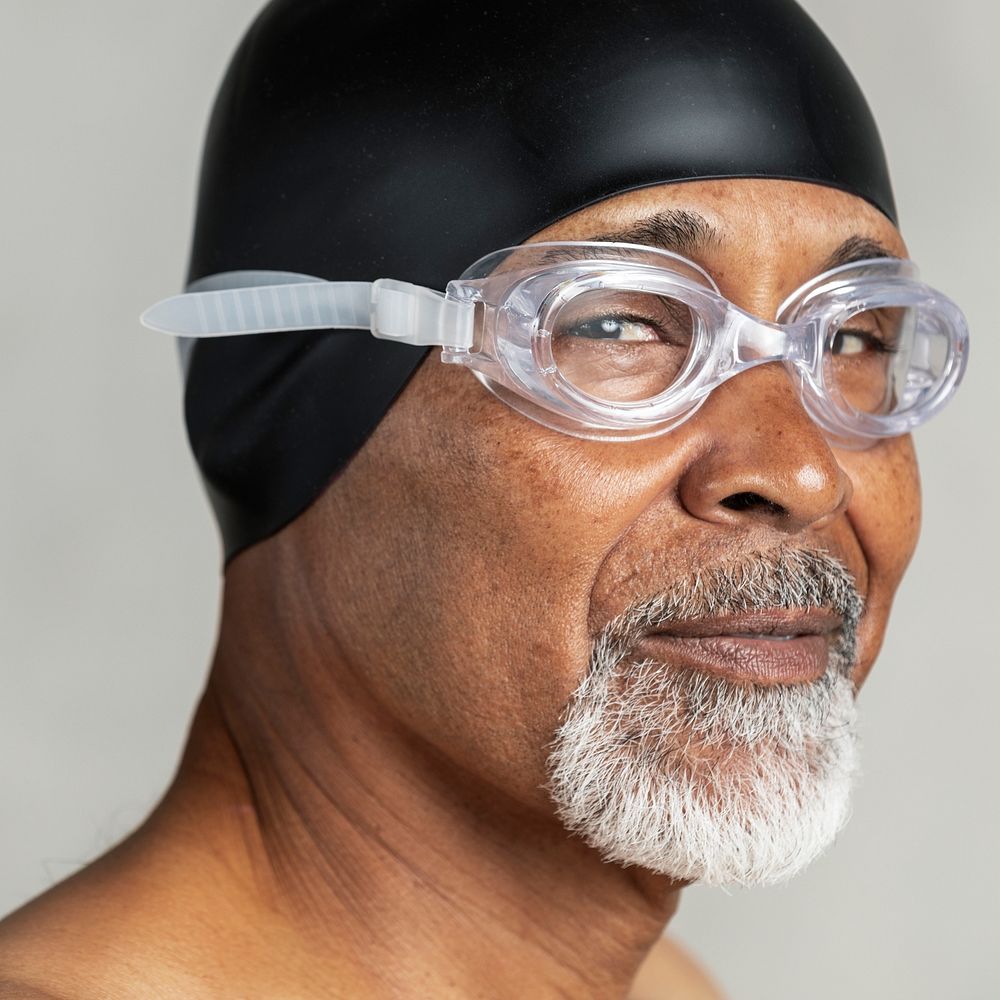 Senior African American swimmer wearing a swim cap and goggles