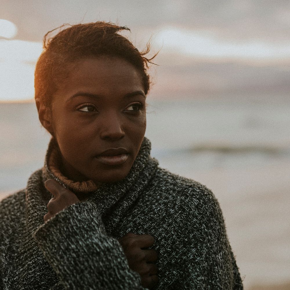 Black woman at the beach during sunset