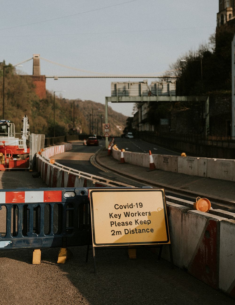 Physical distancing warning sign for roadside construction workers during the covid-19 pandemic